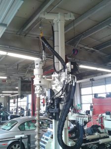 Geoprobe 7822DT utilizing hollow stem augers to install a groundwater monitor well inside a tire service center